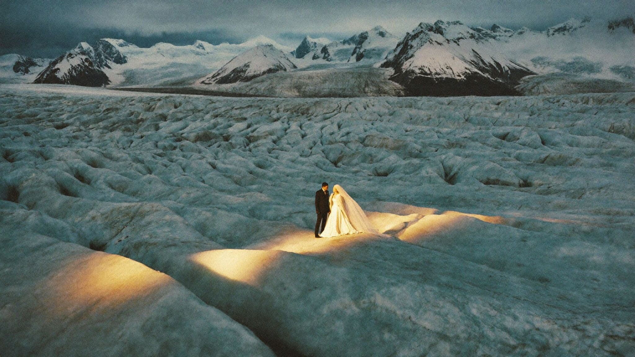 Couple exchanging vows on blue glacier ice during their Alaska elopement