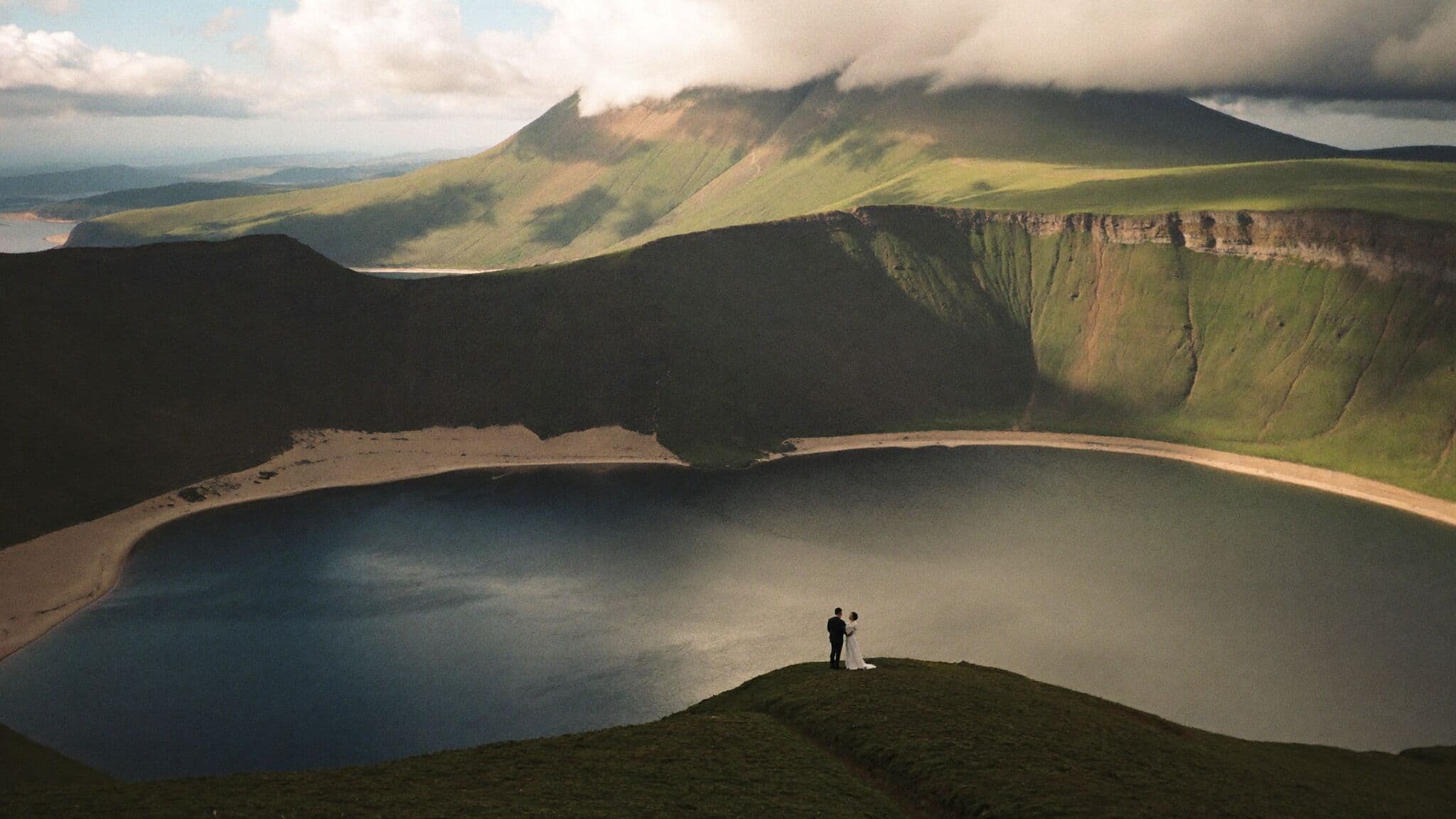 Bride and groom above Lagoa do Fogo as clouds clear, Azores elopement