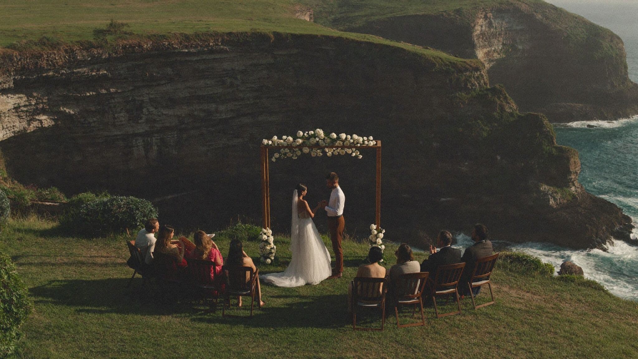 Villa clifftop ceremony above the ocean at golden hour, Bali elopement