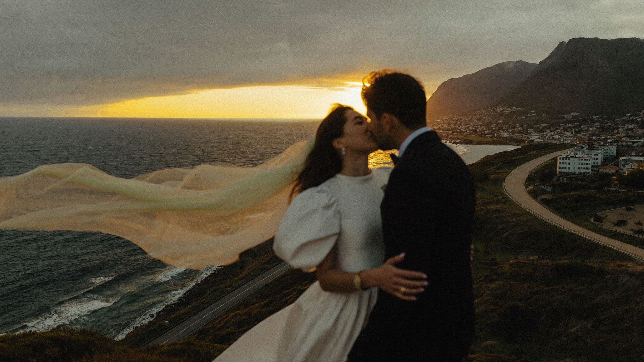 Couple at a Chapman's Peak viewpoint above the Atlantic at sunset, Cape Town elopement