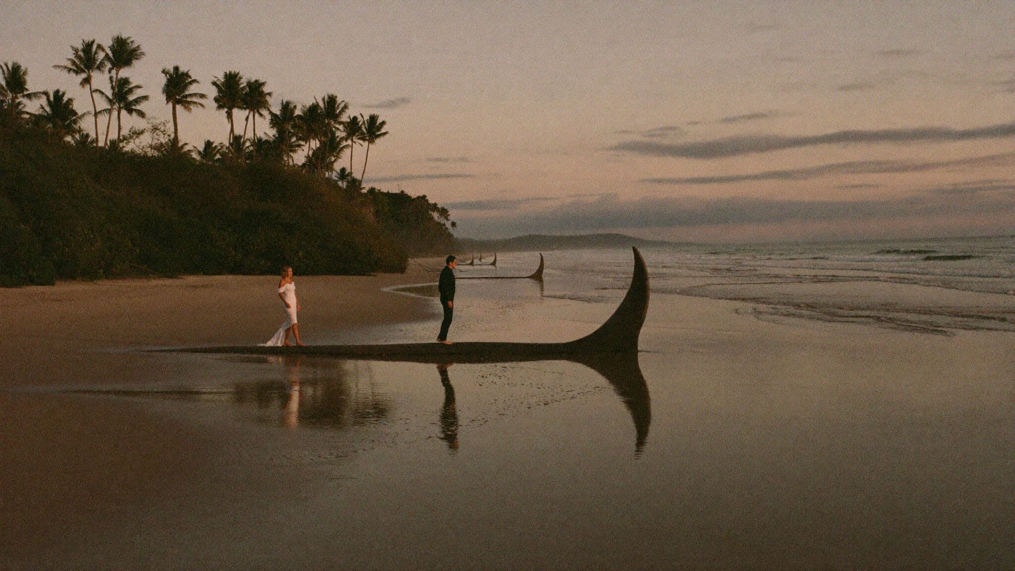 Newlyweds walking the Whale's Tail sandbar at low tide during their Costa Rica elopement