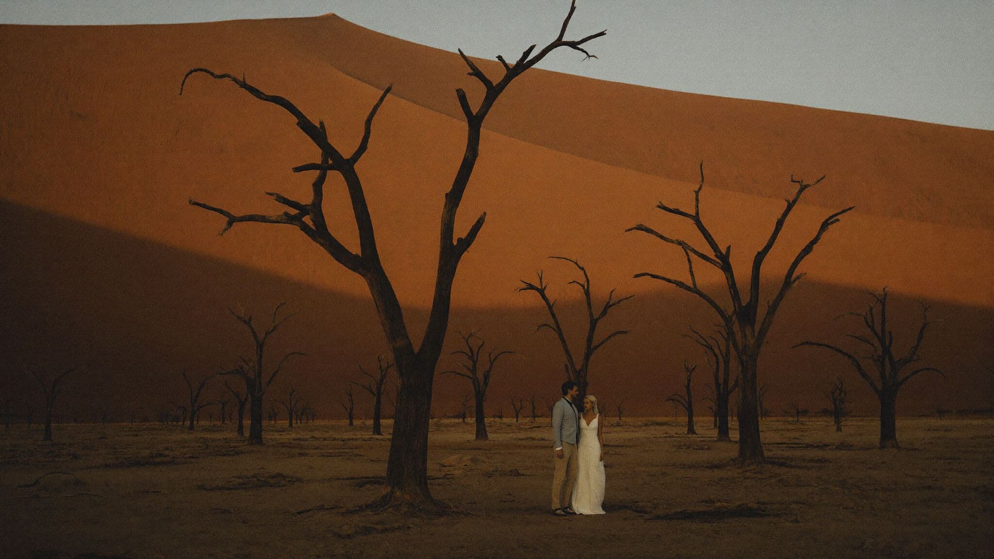 Couple among the ancient camelthorn trees of Deadvlei during their Namibia elopement