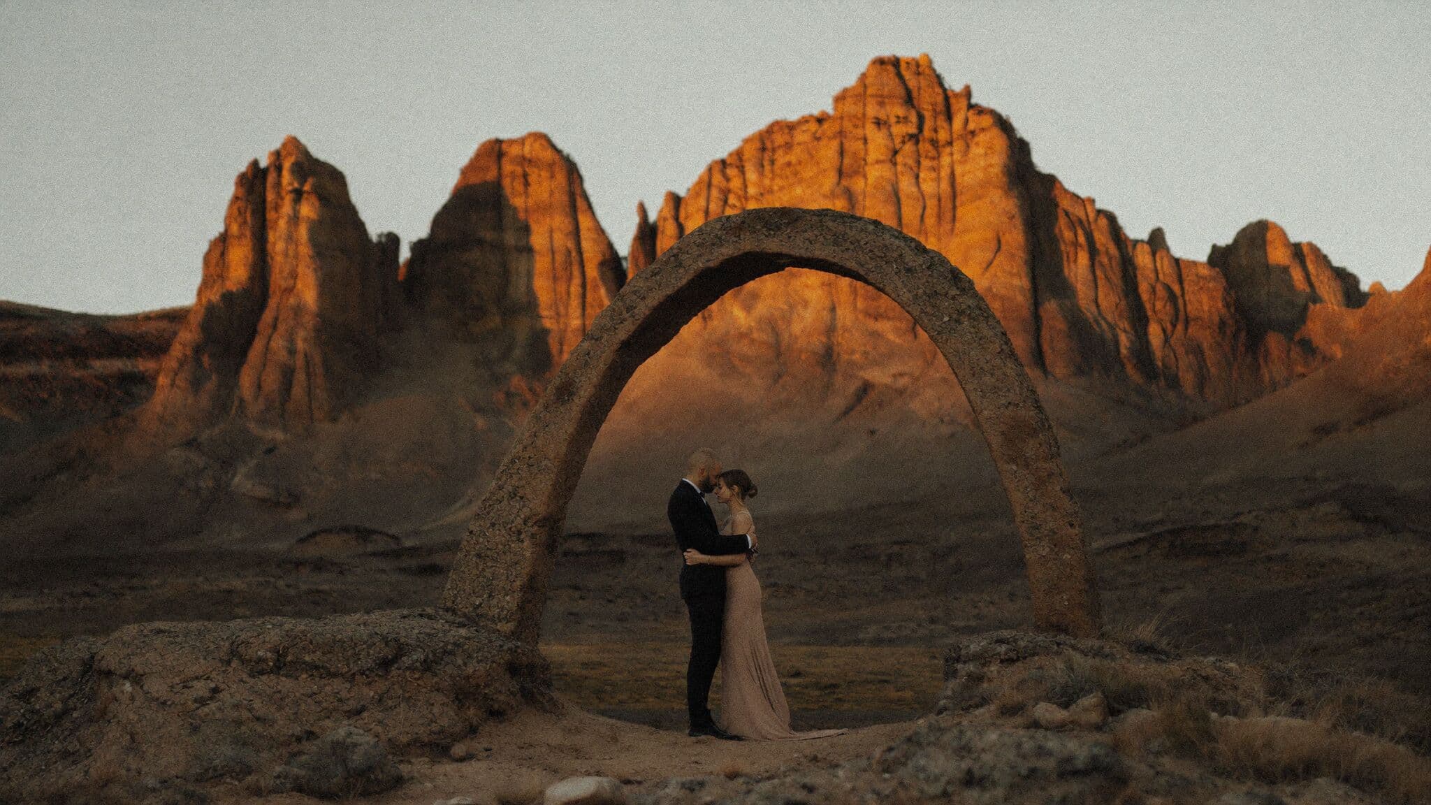 Ceremony beneath the Spitzkoppe granite arch at sunset during a Namibia elopement