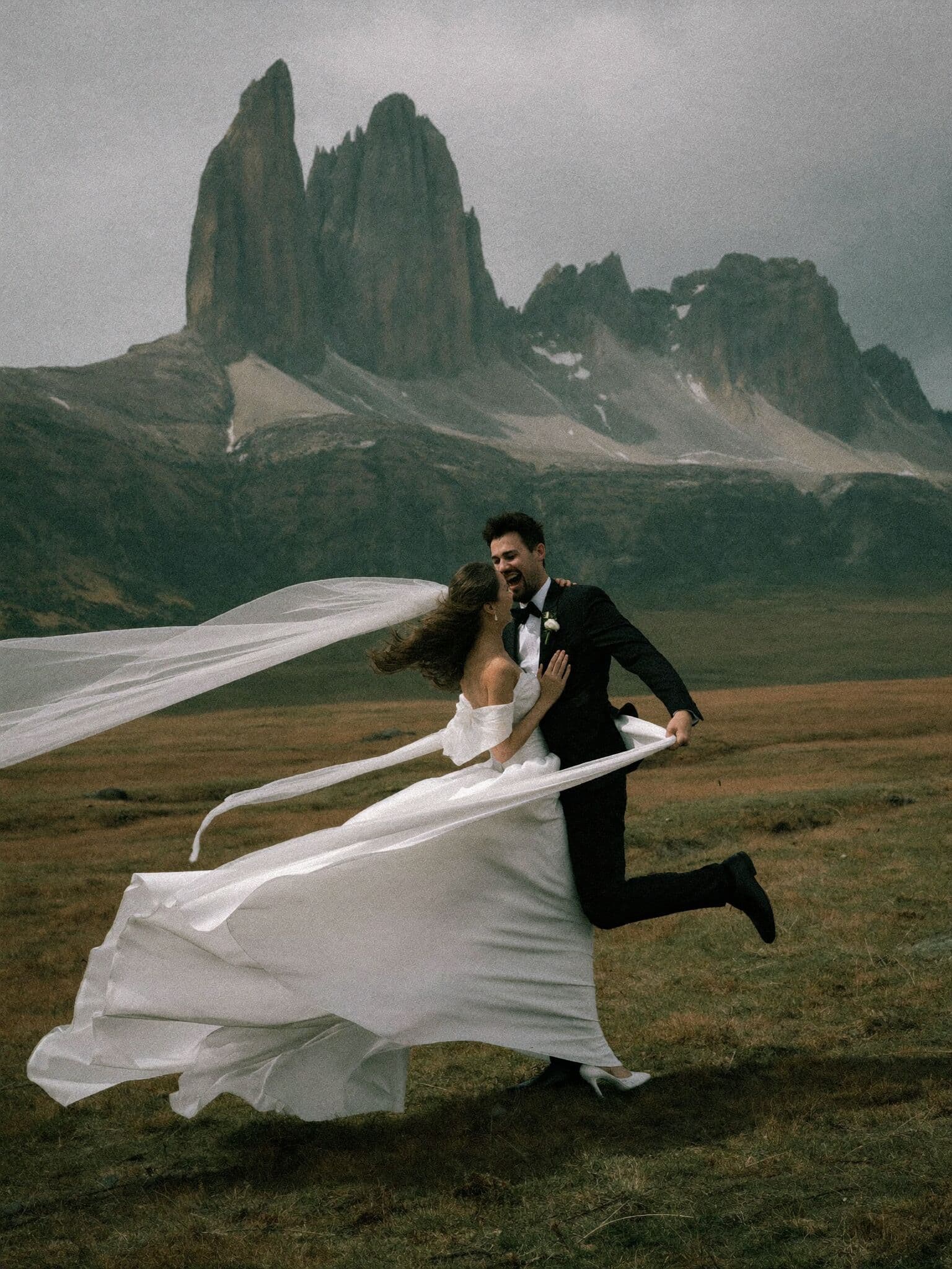 Bride's veil streaming in the Patagonian wind below granite peaks during a Patagonia elopement