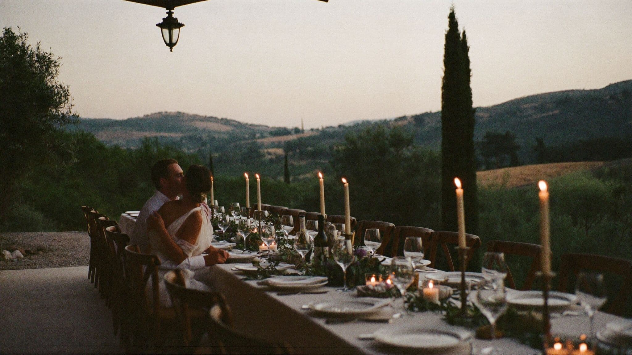 Elopement dinner under pergola vines at a Tuscan villa at dusk