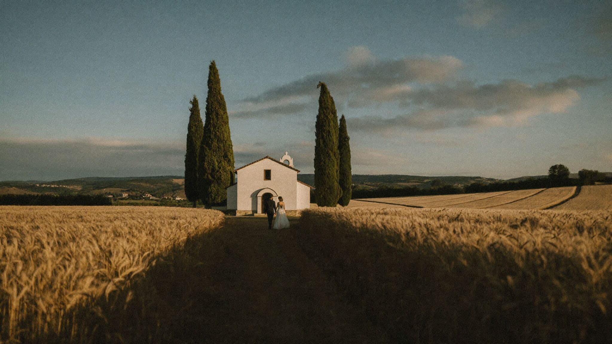Couple exchanging vows at the Vitaleta chapel between cypress trees, Tuscany elopement
